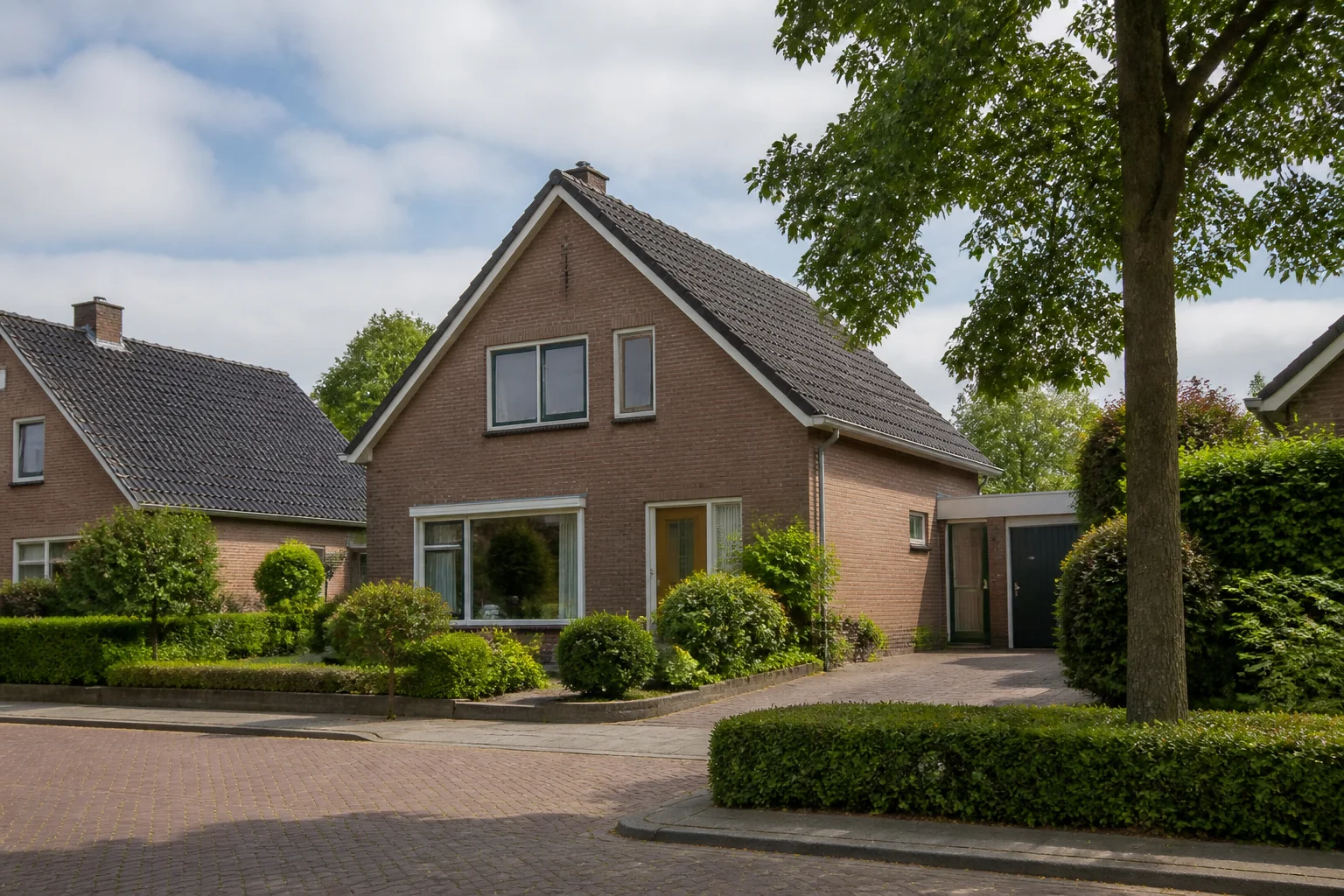 Representative brick family home with garden and driveway in Maarheeze