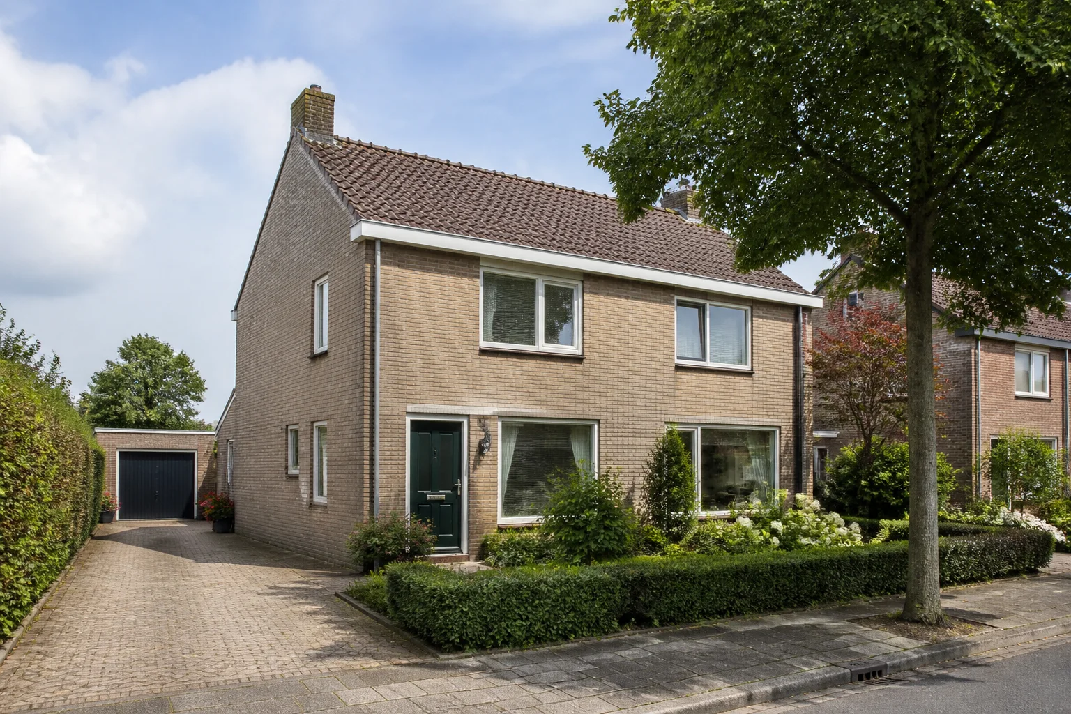 Representative brick family home with garden and driveway in Riethoven