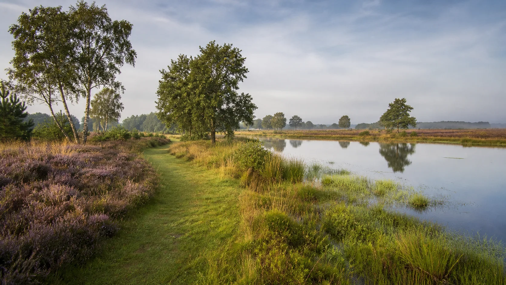 House Valuation in Someren 3 Someren historic brick homes beside a green water-side setting in North Brabant