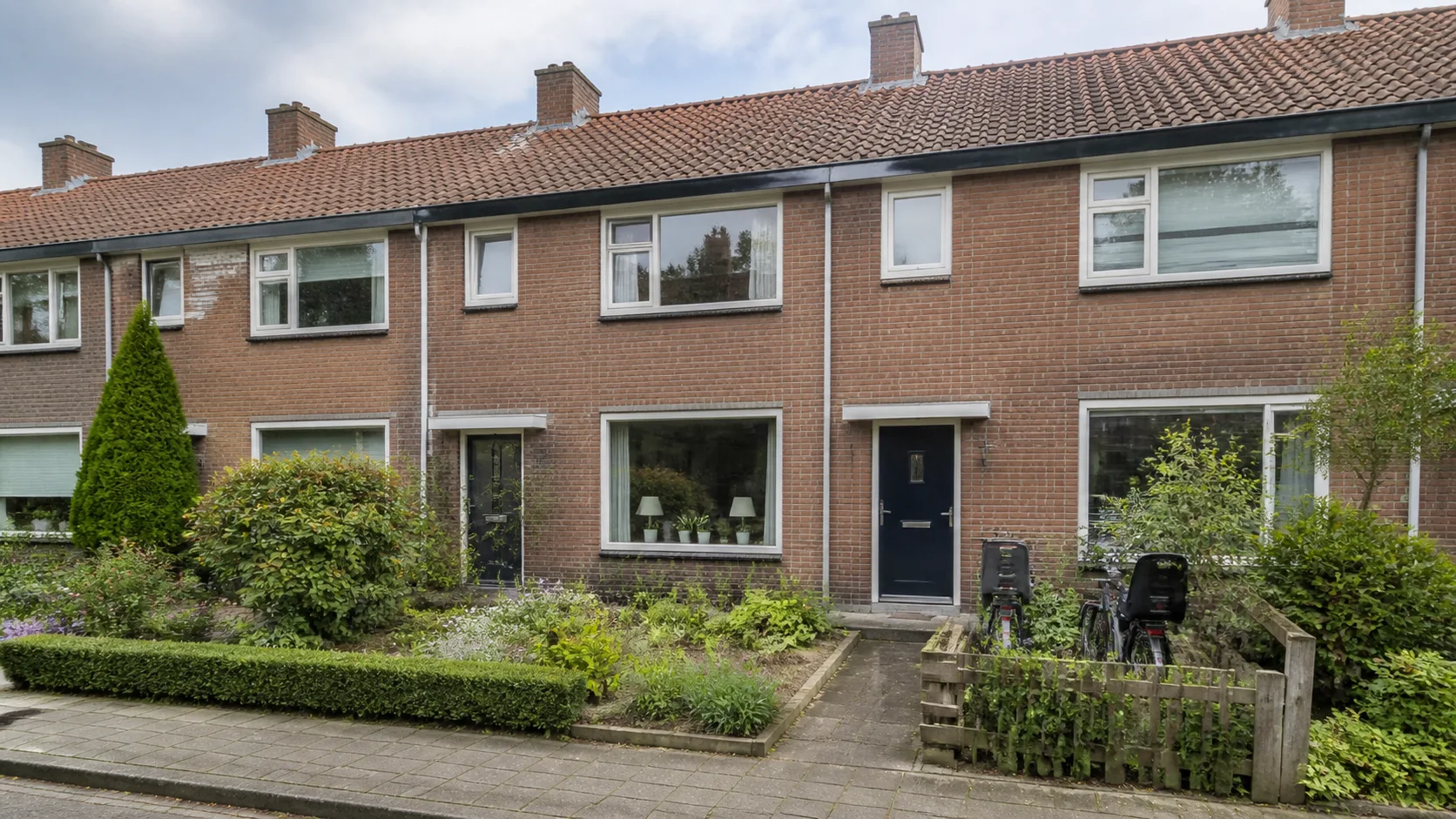 Representative Woensel residential home with brick frontage, garden and mixed urban context